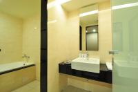 a bathroom with a sink and a mirror at Goodness Plaza Hotel in Taishan