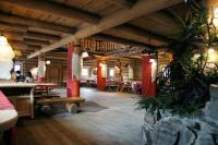 a large room with tables and chairs in a building at Noclegi Styrnol & SPA in Zawoja