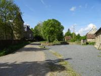 an empty road in a village with houses at LA COURTEILLE in Saint-Fraimbault-sur-Pisse