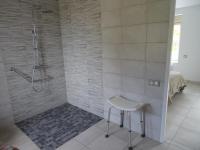a shower with a white stool in a bathroom at LA COURTEILLE in Saint-Fraimbault-sur-Pisse