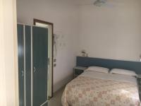 A bed or beds in a room at Hotel Lucerna