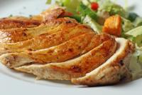 a plate of food with chicken and a salad at Novotel Panama City in Panama City