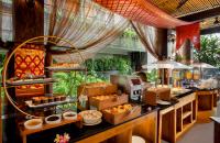 a buffet line with food on display in a restaurant at Astagina Resort Villa and Spa in Legian