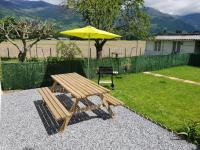 a picnic table and an umbrella in a backyard at Appartement T2 in Lau-Balagnas