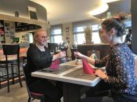 two women sitting at a table with glasses of wine at Hotel Schröder in Losheimergraben