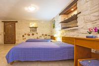 A bed or beds in a room at The Vivian - Luxury Stone Villa