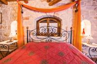 A bed or beds in a room at The Vivian - Luxury Stone Villa