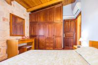 A bed or beds in a room at The Vivian - Luxury Stone Villa