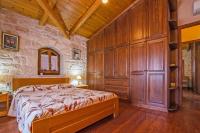 A bed or beds in a room at The Vivian - Luxury Stone Villa