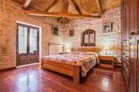 A bed or beds in a room at The Vivian - Luxury Stone Villa