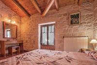 A bed or beds in a room at The Vivian - Luxury Stone Villa
