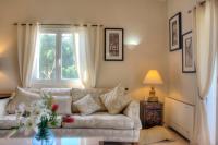 a living room with a couch and a window at Oleander villa in Kouramaditika