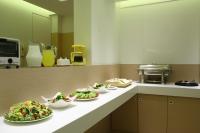 a kitchen with plates of food on a counter at Hsiangkelira Hotel in Kaohsiung