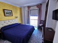 Postel nebo postele na pokoji v ubytování Hotel Doña Carmen