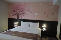 Postel nebo postele na pokoji v ubytování Travel Art Inn