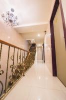 a staircase in a house with a chandelier at Longshan Inn in Taipei