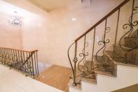 a staircase in a home with a chandelier at Longshan Inn in Taipei