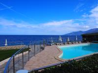 a swimming pool with a view of the ocean at Hotel Tettola in Saint-Florent