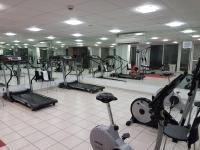 a gym with several treadmills and elliptical machines at Logis Hôtel La Fauceille in Perpignan