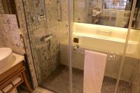 a bathroom with a shower and a toilet and a sink at Chateau de Chine Xinzhuang in Xinzhuang