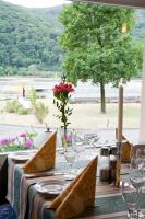 a table with wine glasses and a table with a view at Hotel Zwei Mohren in Rüdesheim am Rhein