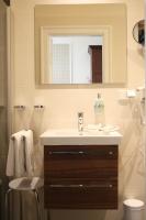 a bathroom with a sink and a mirror at Hotel Villa Altenburg in Pößneck