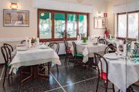 um restaurante com mesas e cadeiras em uma sala em Hotel Tirreno em Celle Ligure