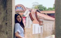 a woman looking out of a window of a building at I-Shan B&amp;B in Jincheng