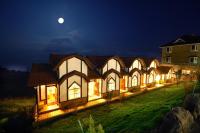 a large building at night with the moon in the sky at Sea of Clouds Vacation Villa in Ren&#39;ai