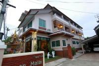 a white house with a sign in front of it at Baanmalai Hotel Chiangrai in Chiang Rai