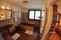 a bathroom with a bath tub and a sink at Hôtel-Logis La Coraline in Gannat