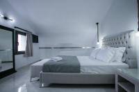 A bed or beds in a room at Anemos Luxury Apartments