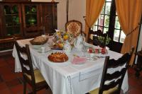 a table with a white table cloth and food on it at Hôtel-Logis La Coraline in Gannat