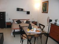 a room with a bed and a table with food on it at STUDIO AU COEUR de CARTHAGE HANNIBAL in Carthage