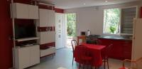 a kitchen with a table with a red table cloth at Clos l&#39;Oustal in Labastide-de-Virac