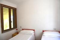 A bed or beds in a room at Domus Carlotta Apartment with sea view Villasimius