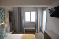 Łóżko lub łóżka w pokoju w obiekcie Hostal Cala Ratjada