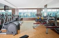 a gym with a lot of treadmills and ellipticals at Treppan Hotel & Suites By Fakhruddin in Dubai