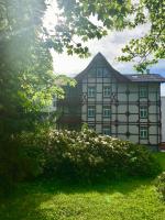 a large building with a green lawn in front of it at Jelena103 Tatranska Lomnica in Tatranská Lomnica