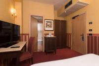 a hotel room with a bed and a desk and a television at Best Western Hotel Tritone in Mestre