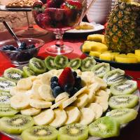 a table topped with plates of fruit on a table at Palazzetto Rosso - Art Hotel in Siena