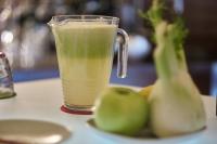 a glass of green juice next to some green pears at Palazzetto Rosso - Art Hotel in Siena
