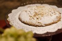 a cake sitting on a plate with powdered sugar on it at Palazzetto Rosso - Art Hotel in Siena