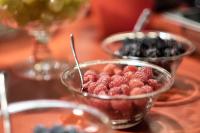 two bowls of raspberries and blueberries on a table at Palazzetto Rosso - Art Hotel in Siena