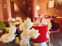 a group of white flowers in a room with stairs at Palazzetto Rosso - Art Hotel in Siena