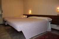 A bed or beds in a room at Albergo Napoleone