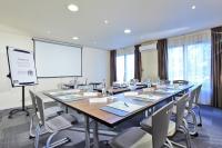 a meeting room with a large table and chairs at Campanile Chanas in Chanas