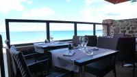 a restaurant with two tables and a view of the ocean at Antinéa in Saint Malo