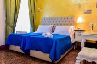 A bed or beds in a room at Palazzo degli Affreschi