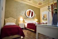 A bed or beds in a room at Palazzo degli Affreschi